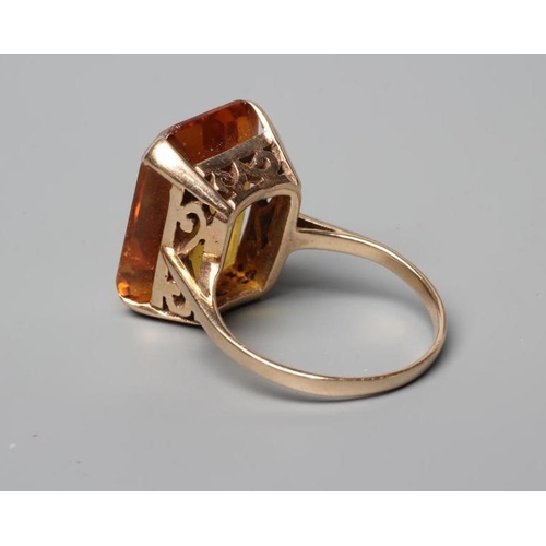 473 - A COCKTAIL RING claw set with an oblong facet cut citrine to a plain, unmarked shank, size N (Est. p... 