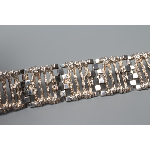 488 - A SILVER BRACELET, Birmingham 1970, (import), the eleven cast and pierced abstract panels with brick... 