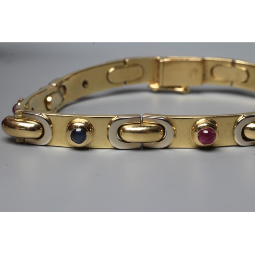 489 - A BRACELET stamped 750, the seven slightly convex oblong panels alternately set with a cabochon poli... 