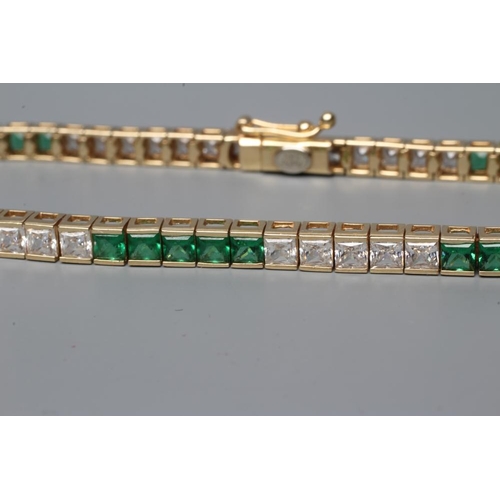 496 - A TENNIS BRACELET bar set with five sets of five square cut green and white pastes, each end with se... 