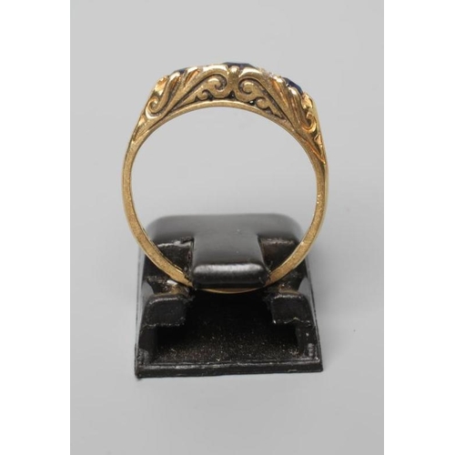 500 - A SEVEN STONE SAPPHIRE AND DIAMOND RING, with carved scroll shoulders and plain 18ct gold shank, Bir... 