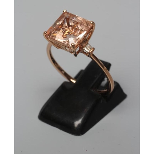 509 - A MORGANITE DRESS RING, the Asscher cut stone claw set and with two small baguette cut stones to eac... 