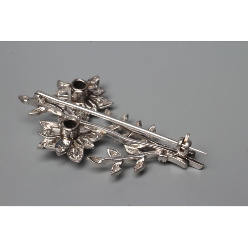 522 - A DIAMOND FLOWER SPRAY BROOCH, the two flowerhead clusters with three leafy branches to an unmarked ... 