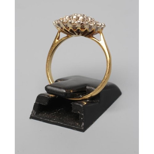 523 - A DIAMOND CLUSTER RING, the central stone within a double border of point set stones to a plain 18ct... 