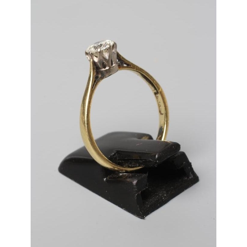 527 - A SOLITAIRE DIAMOND RING, the round brilliant cut stone of approximately 0.60cts, claw set to a plai... 