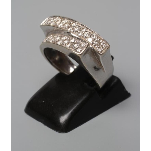 529 - A DIAMOND CROSSOVER STYLE RING, the two panels point set with numerous small stones to a wide white ... 