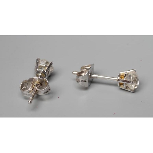 534 - A PAIR OF SOLITAIRE DIAMOND EAR STUDS, the old cut stones totalling approximately 0.6cts claw set to... 