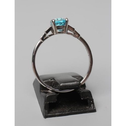 536 - A DRESS RING, the oblong facet cut blue zircon of approximately 1.58cts claw set to stepped shoulder... 