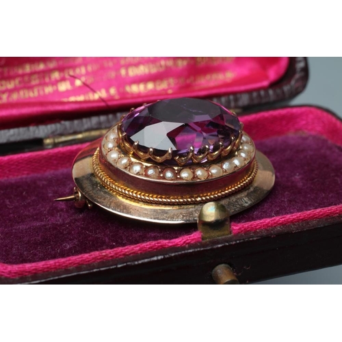 539 - A LATE VICTORIAN AMETHYST BROOCH, the oval facet cut stone set to a border of seed pearls in a plain... 