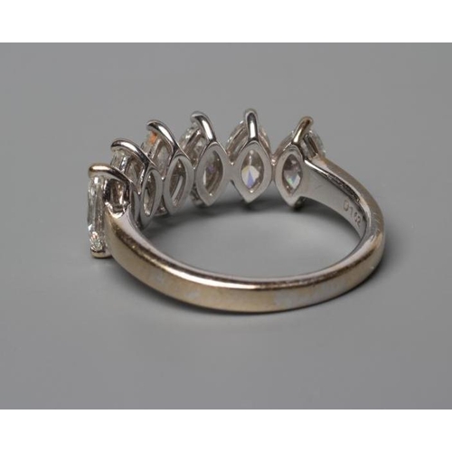 542 - A SIX STONE DIAMOND RING, the marquise cut stones totalling 1.62cts claw set to a plain shank, stamp... 