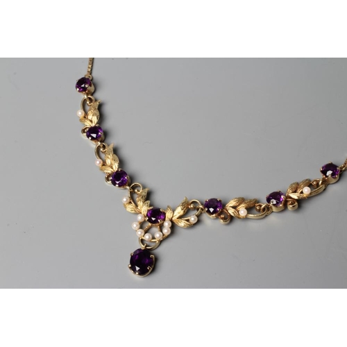 550 - AN AMETHYST NECKLACE, the seven circular facet cut stones claw set to leafy links with seed pearl mo... 