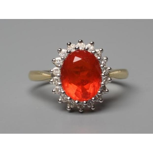 555 - A FIRE OPAL AND DIAMOND CLUSTER RING, the oval facet cut opal within a border of eighteen point set ... 