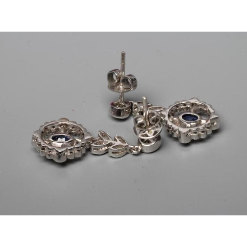 565 - A PAIR OF EDWARDIAN STYLE SAPPHIRE AND DIAMOND DROP EARRINGS, the oval facet cut sapphire collet set... 