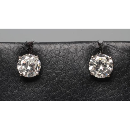 570 - A PAIR OF DIAMOND SOLITAIRE EAR STUDS, the brilliant round cut stones each of approximately 1.25cts,... 