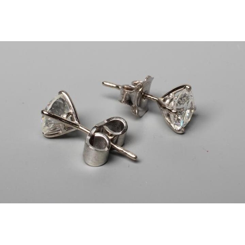 570 - A PAIR OF DIAMOND SOLITAIRE EAR STUDS, the brilliant round cut stones each of approximately 1.25cts,... 