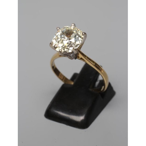 581 - A SOLITAIRE DIAMOND RING, the Victorian cut stone of approximately 3.17cts, claw set to a plain 18ct... 