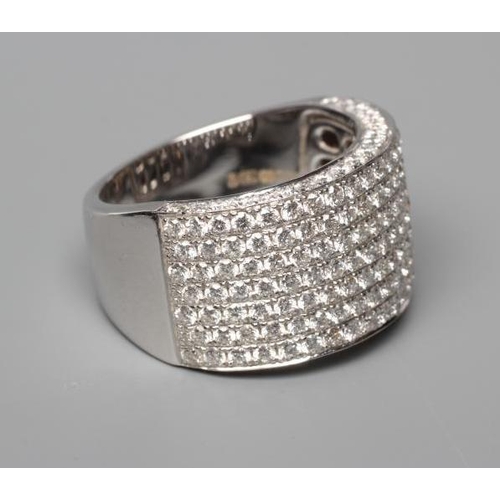 585 - A HALF HOOP DIAMOND COCKTAIL RING, the nine rows set with point set round brilliant cut stones total... 