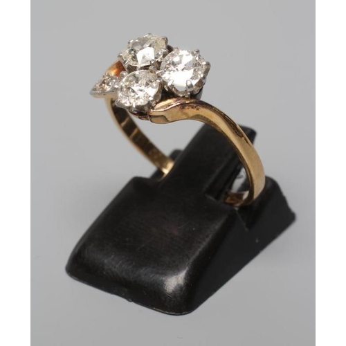 588 - A THREE STONE DIAMOND RING, the old brilliant cut stones each of approximately 0.35cts claw set to a... 