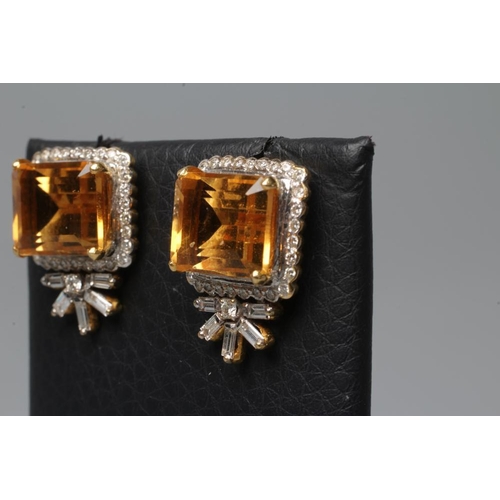 592 - A PAIR OF EDWARDIAN STYLE EAR STUDS, the oblong facet citrines claw set to a border of numerous smal... 