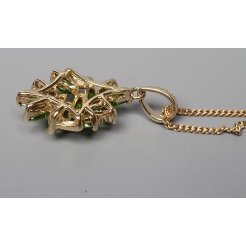 596 - A TSAVORITE GARNET AND DIAMOND ABSTRACT CLUSTER PENDANT, stamped 14k, on a 9ct gold fine chain neckl... 