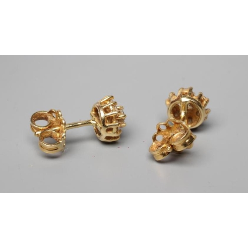 600 - A PAIR OF DIAMOND CLUSTER EAR STUDS, stamped 18ct (Est. plus 24% premium inc. VAT)