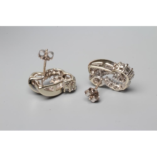 602 - A PAIR OF DIAMOND STUD EARRINGS, the open scrolls point set with thirteen round brilliants and fifte... 