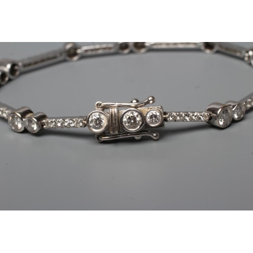 605 - A DIAMOND BRACELET, open back collet set with six pairs and five single round brilliant cut stones, ... 