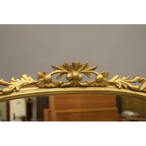 941 - A VICTORIAN GILT WOOD PIER GLASS, the arched plate within a moulded frame with pierced and carved sc... 