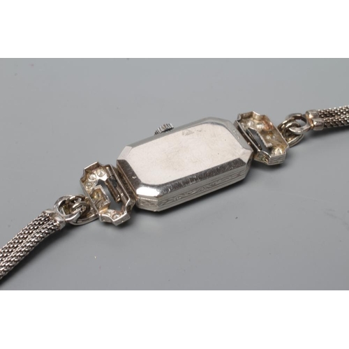 399 - A DIAMOND COCKTAIL WATCH, the silvered dial with black Arabic numerals, the un-numbered jewelled mov... 