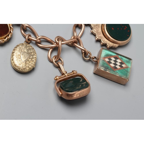 524 - A 9CT GOLD CHARM BRACELET hung with a loose mounted 1912 sovereign, a double sided pietra dura oblon... 