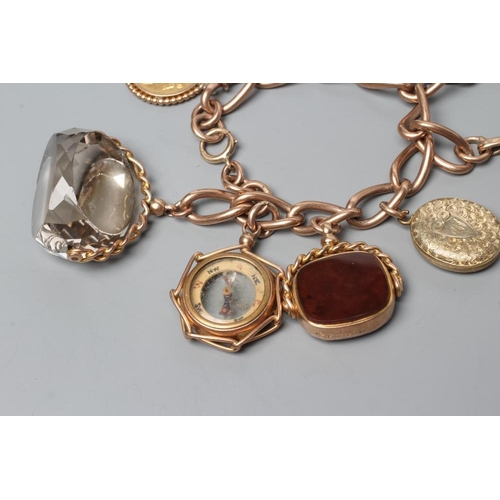 524 - A 9CT GOLD CHARM BRACELET hung with a loose mounted 1912 sovereign, a double sided pietra dura oblon... 