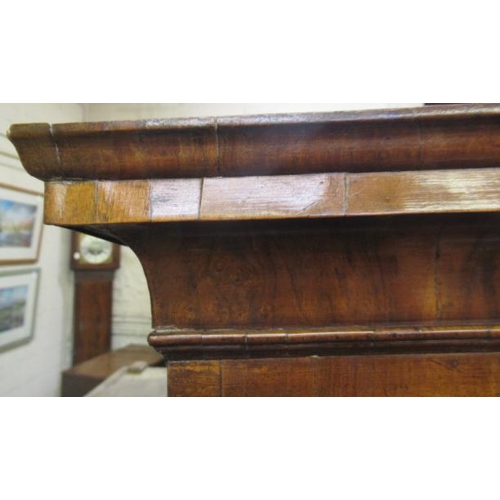 921 - A GEORGIAN WALNUT CHEST ON STAND, mid 18th century, crossbanded with feather stringing, the cavetto ... 