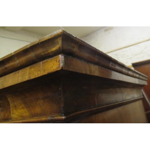 921 - A GEORGIAN WALNUT CHEST ON STAND, mid 18th century, crossbanded with feather stringing, the cavetto ... 