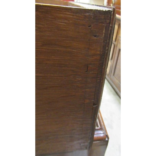 921 - A GEORGIAN WALNUT CHEST ON STAND, mid 18th century, crossbanded with feather stringing, the cavetto ... 