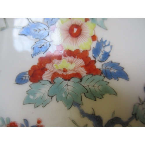 28 - A MEISSEN PORCELAIN TEA CUP AND SAUCER, 19th century, painted in the Kakiemon palette with an exotic... 