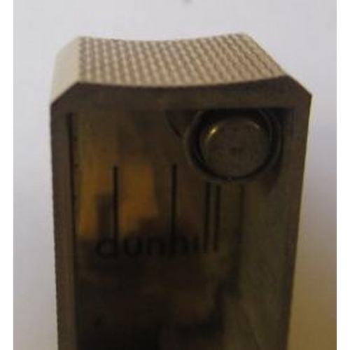 152 - A DUNHILL 9CT GOLD ROLLAGAS CIGARETTE LIGHTER of plain oblong form with engine turning, 2 1/2