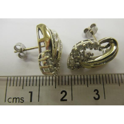 602 - A PAIR OF DIAMOND STUD EARRINGS, the open scrolls point set with thirteen round brilliants and fifte... 