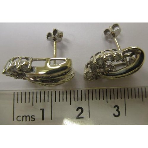 602 - A PAIR OF DIAMOND STUD EARRINGS, the open scrolls point set with thirteen round brilliants and fifte... 