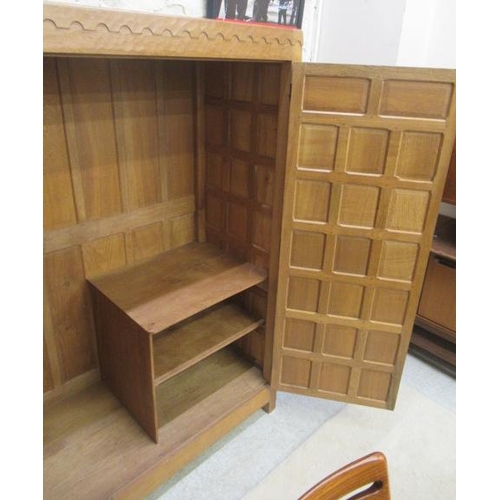 880 - A ROBERT THOMPSON ADZED OAK WARDROBE of oblong multi panelled form with half penny moulded cornice, ... 