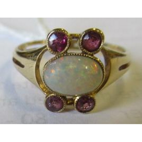 428 - A MURRLE BENNETT DRESS RING, the oval cabochon polished opal collet set with two pairs of small rubi... 