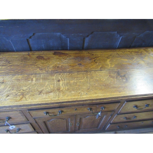 936 - A GEORGIAN OAK AND MAHOGANY BANDED ENCLOSED DRESSER, late 18th century, the moulded edged top over c... 