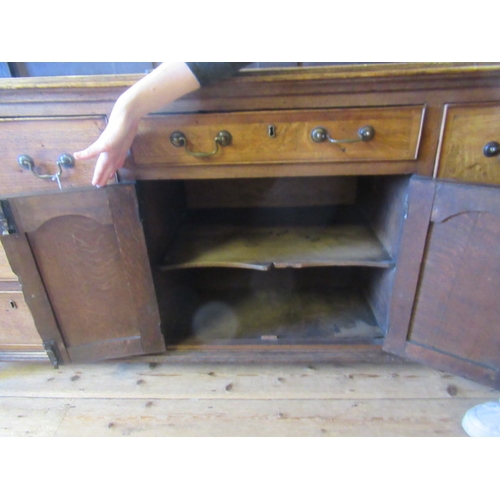 936 - A GEORGIAN OAK AND MAHOGANY BANDED ENCLOSED DRESSER, late 18th century, the moulded edged top over c... 