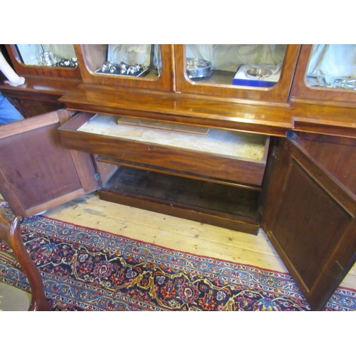 926 - A VICTORIAN MAHOGANY BREAKFRONT LIBRARY BOOKCASE, the moulded cornice over four arched glazed doors,... 