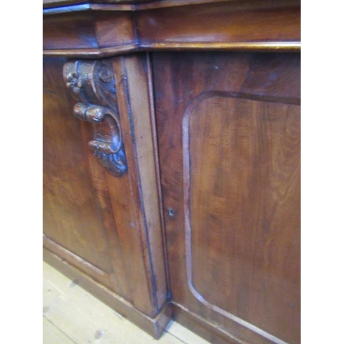 926 - A VICTORIAN MAHOGANY BREAKFRONT LIBRARY BOOKCASE, the moulded cornice over four arched glazed doors,... 