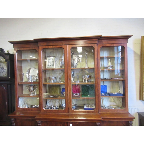 926 - A VICTORIAN MAHOGANY BREAKFRONT LIBRARY BOOKCASE, the moulded cornice over four arched glazed doors,... 