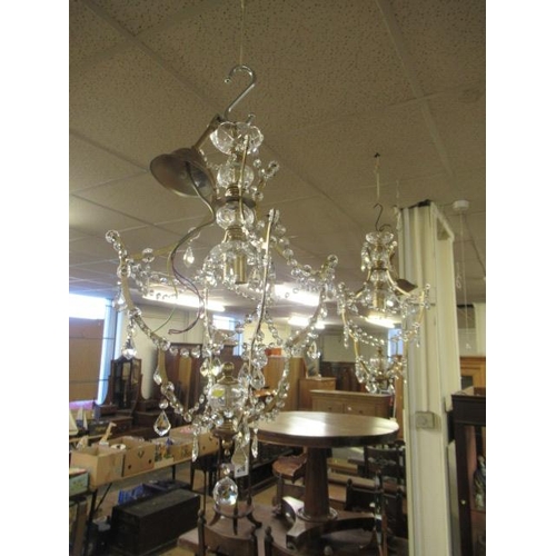 376 - PAIR OF CRYSTAL AND BRASS CHANDELIERS