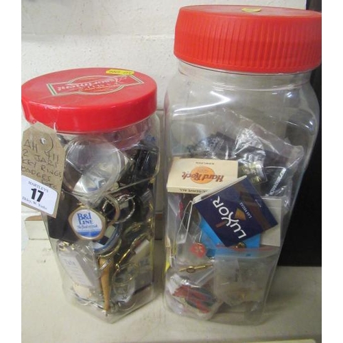 17 - TWO JARS OF KEY RINGS AND BADGES ETC