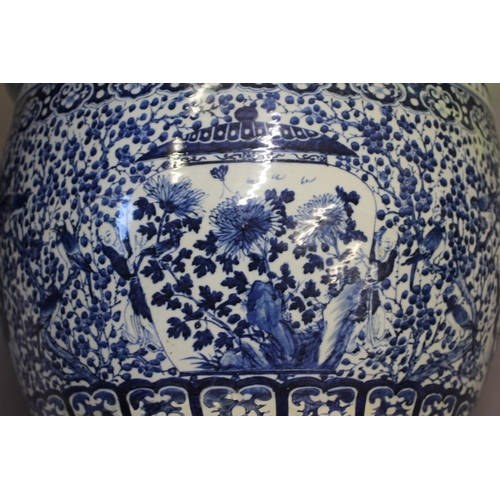 10 - A LARGE CHINESE PORCELAIN JARDINIERE of baluster form painted in underglaze blue with panels of flow... 