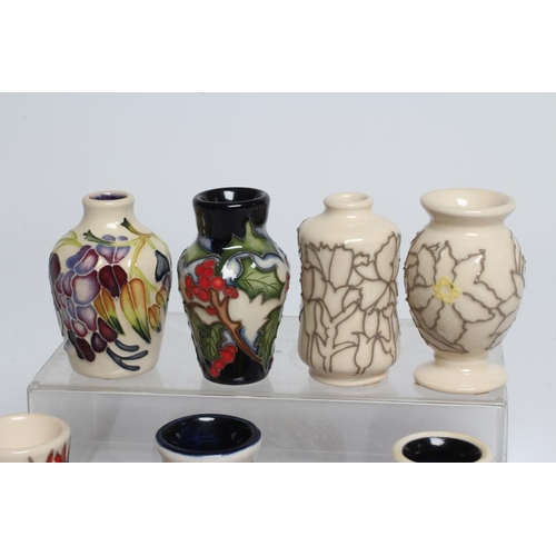 109 - A COLLECTION OF NINE MINIATURE MOORCROFT POTTERY VASES, comprising Heart to Heart, Christmas Crown, ... 