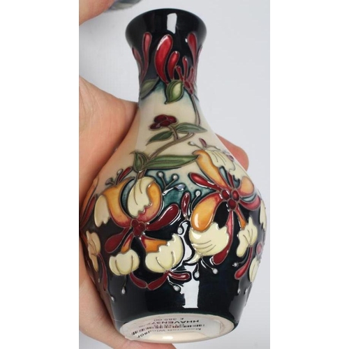 114 - A MOORCROFT POTTERY SMALL BOTTLE VASE, modern, painted in colours with the Honeysuckle Haven pattern... 